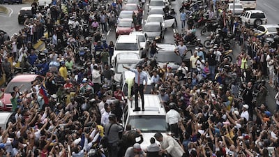 Juan Guaido, president of the National Assembly who swore himself in as the leader of Venezuela, centre, stands on a vehicle during a protest against Venezuelan President Nicolas Maduro in Caracas, Venezuela, on Tuesday, March 12, 2019. Bloomberg