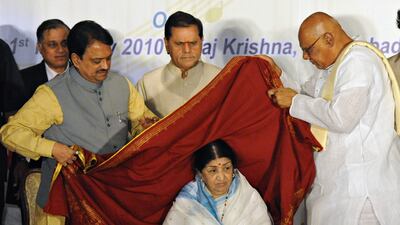 Mangeshkar with Vilasrao DeshMukh, Indian union minister of heavy industries, left, T Subbarami Reddy, member of parliament, centre, and K Rosaiah, chief minister of Andhra Pradesh, in February 2010, when she was presented with the Akkineni Nageswara Rao National Award. AFP