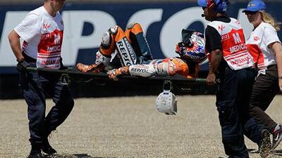 Casey Stoner got up after his crash, then quickly grabbed his right ankle and went right down. The Australian needed help via a stretcher and crew to be moved to the infield medical centre.
