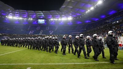 Police leave the pitch after a Bundesliga match between Hamburg and VfB Stuttgart. Getty