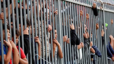 Fans watch the match World Cup 2022 and Asian Cup Qualifier between Palestine and Saudi Arabia at Faisal Al-Husseini International Stadium, Al-Ram, West Bank. Reuters