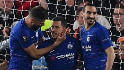 Eden Hazard, centre, is congratulated after scoring Chelsea's winning penalty against Eintracht Frankfurt. AFP