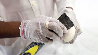 The outer layer of the soap is grated off by hand