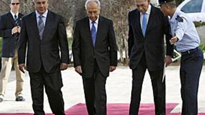 The new Israeli prime minister Benjamin Netanyahu, left, Shimon Peres, the president and the outgoing prime minister Ehud Olmert enter Mr Peres' residence in Jerusalem yesterday.