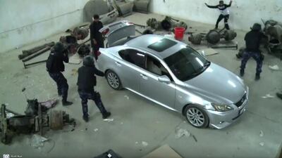 A screen grab from a video released by Sharjah Police showing the arrest of two men who were storing 300kg of hashish in lorry spare parts at a warehouse in the emirate. Courtesy Sharjah Police