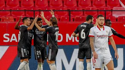 Real Madrid's players celebrate their goal against Sevilla at the Ramon Sanchez Pizjuan Stadium. AP