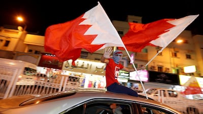 Bahrainis wave flags from moving cars after winning the Gulf Cup final against Saudi Arabia, in Riffa, south of Manama, Bahrain. Reuters