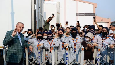 Recep Tayyip Erdogan joins scouts in a salute at the Mediterranean town of Marmaris, in Mugla province. The area has been hit by numerous wildfires in recent days, amid sweltering heat and with strong winds fanning flames.