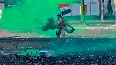 Security forces fire tear gas and smoke bombs during clashes between Iraqi security forces and anti-government protesters in Baghdad, Iraq. AP Photo