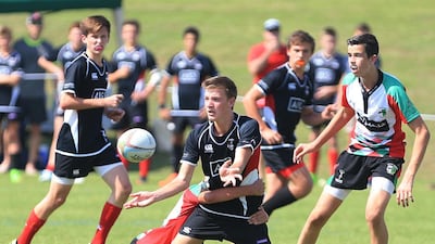 England international Ugo Monye interacts with children during his visit to the Etihad Airways Abu Dhabi Harlequins Junior Rugby tournament at Zayed Sports City in Abu Dhabi on Saturday. Ravindranath K / The National