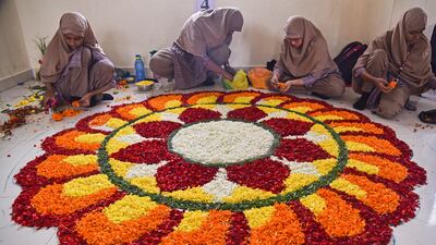 Muslim students decorate a flower carpet, or 'pookalam', during a competition as part of the Onam festival celebrations in Chennai, India. EPA