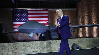 Mr Trump on stage as he tours Al Udeid Airbase in Doha, Qatar in 2025. Getty Images