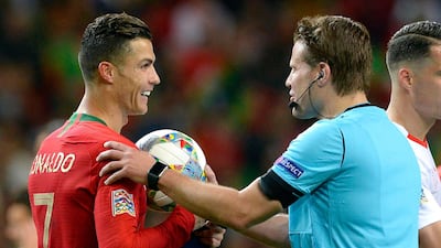 Ronaldo receives the match ball from German referee Felix Brych. EPA