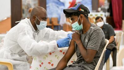 A man receives a dose of a vaccine against Covid-19 at St Paul’s Church in Abu Dhabi. Khushnum Bhandari / The National