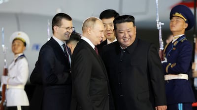 Mr Putin and Mr Kim share a laugh. Korean Central News Agency / Reuters