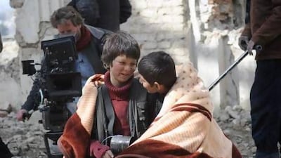 On the set of the Oscar-nominated film Buzkashi Boys are the lead actors Jawanmard Paiz, center, Fawad Mohammadi, right, and the director Sam French. David Gill, Afghan Film Project / AP Photo