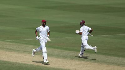 West Indies' cricketer Shane Dowrich, right, and Roston Chase run between the wickets during the first day of the second cricket test match between India and West Indies in Hyderabad, India.