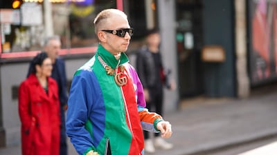 A guest wears a Gucci shell suit during London Fashion Week Men's June 2019. Getty Images