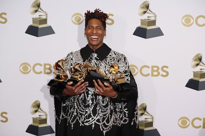 Jon Batiste poses in the press room with his Grammys. EPA