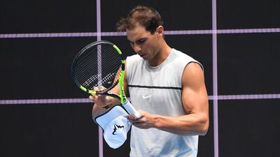 Rafael Nadal adjusts his racket during a practice session. Julian Smith / EPA
