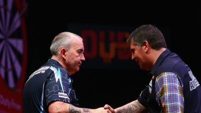 Phil Taylor, left, shakes hands with Gary Anderson after their semi-final. Francois Nel / Getty