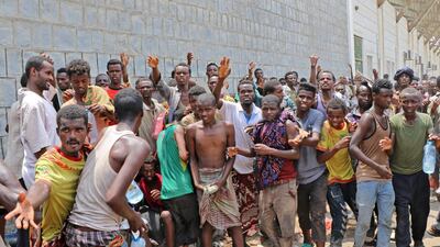 African migrants receive food and water inside a football stadium in the Red Sea port city of Aden in Yemen. AFP