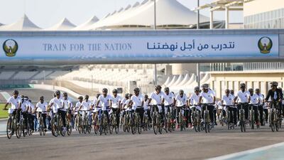 UAE army personnel cycle on the Yas Marina Circuit.
