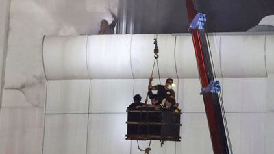 Emergency workers rescue people trapped in the complex. AFP