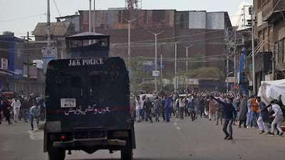 Kashmiri demonstrators throw pieces of bricks and stones towards an Indian police vehicle during a protest after Jumat-ul-Vida on the last Friday prayers as three men jailed for funding of a suicide bombing which killed 40 Indian troops. REUTERS