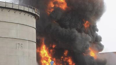 Yemeni firefighters work to extinguish a blaze at an oil refinery in the port city of Aden on July 14, 2015, after storage tanks were hit during rebel rocket attacks. Abo Muhammed/AP Photo
