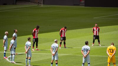 Players observe a minute of silence for coronavirus before the match. AFP