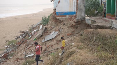 Chandragiri Shyam, 30, with his son. The fisherman was forced relocate to the new fisherman’s colony in 2019, with his three children, after sea waves came into the village.