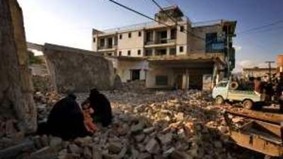 Women sit on rubble of a school blown up by alleged Islamic militants in Mingora, capital of troubled Swat valley in Pakistan.