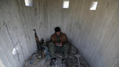 A Turkish-backed Free Syrian Army fighter rests at mount Bafliyun, in the Afrin region. Khalil Ashawi / Reuters