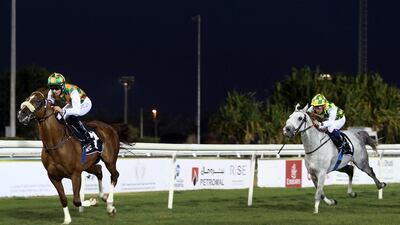 Harry Bentley riding Shateh, left, won first place followed by Wayne Smith riding Sha'Red in the Al Ruwais race on Sunday, February 7, 2015, at the Abu Dhabi Equestrian Club. It was the ninth race meeting in Abu Dhabi. ( DELORES JOHNSON / The National )