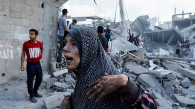 A Palestinian woman surveys the damage following Israeli strikes in Rafah. Reuters