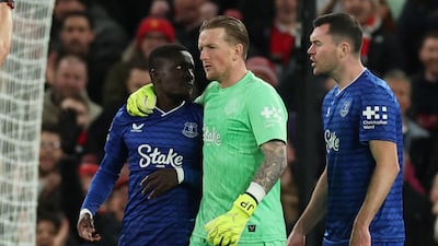 Everton's Idrissa Gueye is held back by teammate Jordan Pickford after slapping Michael Keane and shown a red card by referee Tony Harrington. Reuters