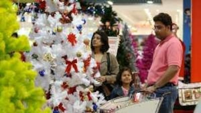 Pankaj Shirodkar, right, with his daughter Nicole and wife Panna, hits the Lulu Hypermarket in Al Barsha for Christmas essentials yesterday.