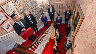 Rishi Sunak holds the budget box inside 11 Downing Street. Reuters