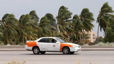 Palm trees battle with heavy winds on a Oman highway as Cyclone Luban approaches. Reuters