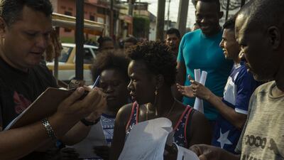 Migrants from Haiti wait in line next to the Mexican Commission for Migrant Assistance office in Tapachula. The flow of migrants into southern Mexico has slowed in recent days as Mexico deploys troops to the border under a tougher new policy adopted under pressure from the Trump administration. AP