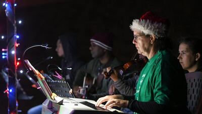 Abu Dhabi, United Arab Emirates - The volunteers play their instruments for the Christmas carols. Khushnum Bhandari for The National