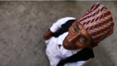 Nepalese Chandra Bahadur Dangi, 72, arrives at the airport in Katmandu, Nepal. Guinness World Records officials will be in Nepal this weekend to measure Mr Dangi who hopes to be named the world's shortest man. Mr Dangi is hoping to snatch the title from Junrey Balawing of the Philippines.