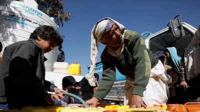Yemenis collect water from a donated tank amid a severe shortage on the outskirts of Sanaa, December 11, 2001. EPA