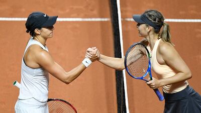 Caroline Garcia, left, and Maria Sharapova greet each other at the net following their first round match at the Stuttgart Open. Thomas Kienzle / AFP