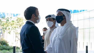 Sheikh Abdullah bin Zayed, Minister of Foreign Affairs and International Co-operation, greets Mr Macron. Photo: Ministry of Presidential Affairs