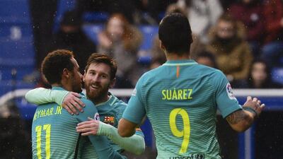 Barcelona's Lionel Messi, centre, celebrates after scoring against Alaves with teammates Luis Suarez and Neymar. Vincent West / Reuters