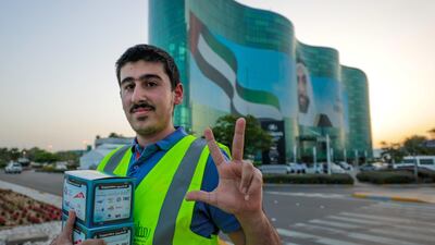 Red Crescent volunteers and Abu Dhabi Police distribute food to motorists during iftar. Victor Besa / The National