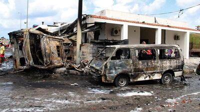 Burned vehicles at the site of the ISIL-claimed bombing in Tartus, Syria, on Monday. SANA via AP