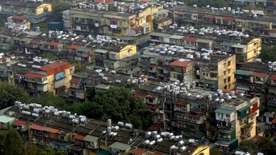 Water storage tanks are seen on top of old condominiums in Hanoi. Kham / Reuters